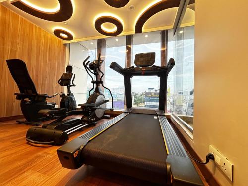 a room with a gym with a treadmill and a window at The Paradise Kingdom in Kanchipuram