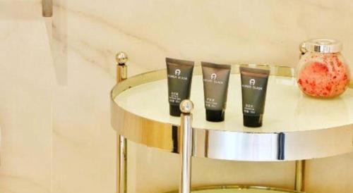 a group of three products sitting on a shelf at Jinjiang Metropolo Hotel Classiq Shanghai Off Bund in Shanghai