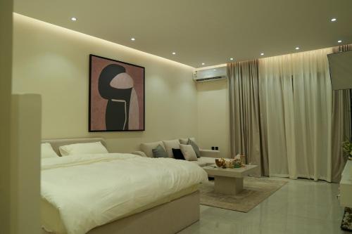 a bedroom with a large bed and a couch at استديوا " بلكونه " in Riyadh