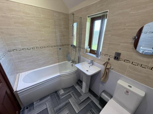 Ένα μπάνιο στο Poppy Lodge-Tranquil-Fishing-Hot Tub-7m to Beach