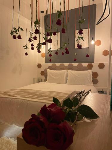 a bedroom with a bed with a bouquet of roses at Romeo apt with private garden in Korçë