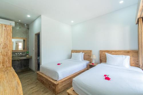 En eller flere senge i et værelse på Su Casa Boutique Hotel Lembongan