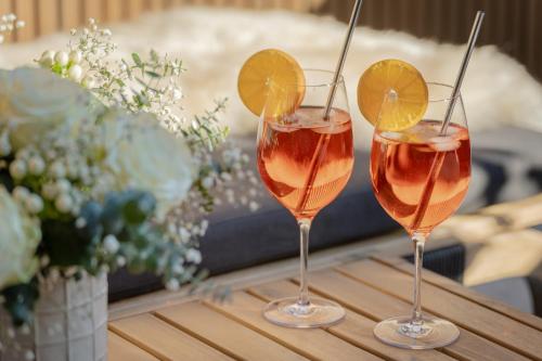 two glasses of wine sitting on a table at Arnestgut in Strobl