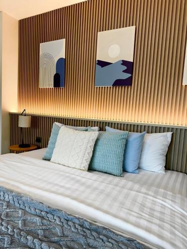 a bedroom with a bed with blue and white pillows at Indigo Studio 2 mins from SRT Wat Samien Nari in Bangkok