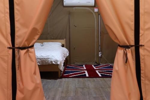 a room with a tent with a bed in it at Hongcheon Oullim Glamping Pension in Hongcheon