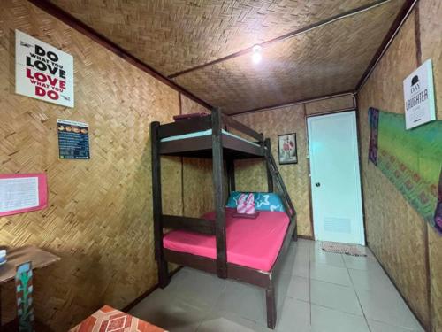 a small room with a bunk bed in a house at El Nido mama hostel in El Nido
