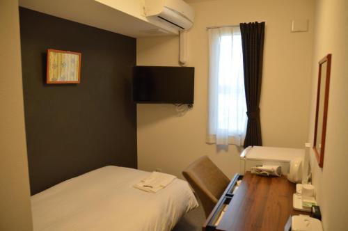 Postel nebo postele na pokoji v ubytování Hotel Ocean Tomioka