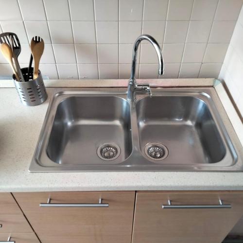 a stainless steel sink in a kitchen with utensils at Carlo e Dani Flat in Venice in Venice