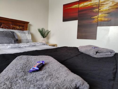 a bedroom with two beds with towels on the bed at Corella Accommodation - 1F in Boulder