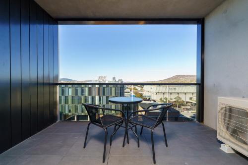 a balcony with a table and chairs and a view at Luxury Living and Pool Views in the Heart of Woden - Hosted by Canstay in Phillip