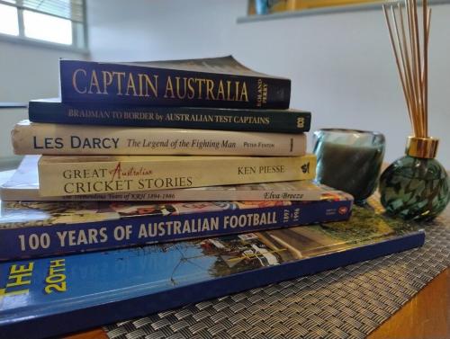 a stack of books sitting on top of a table at Corella Accommodation - 1F in Boulder