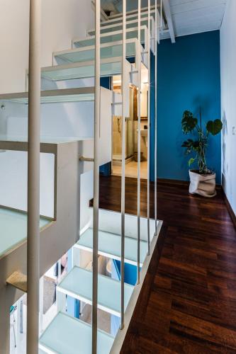 a staircase in a house with blue walls and wooden floors at Amazing Sea View Flat in Tirrenia