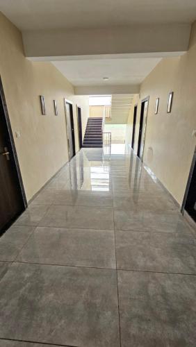 an empty hallway of a building with a staircase at Heaven's Hotel &Resort in Ratlām