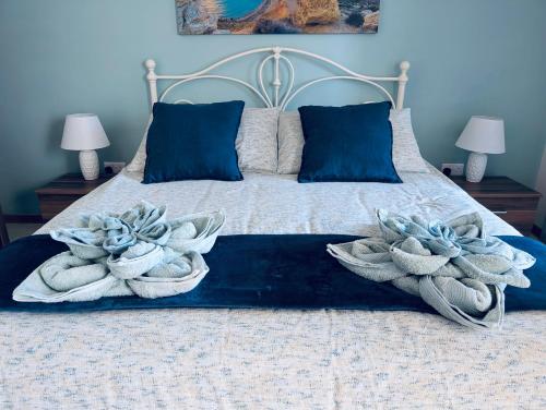 a bedroom with a bed with two towels on it at Sunset Haven Manikata - Walking distance to Golden Bay in Manikata