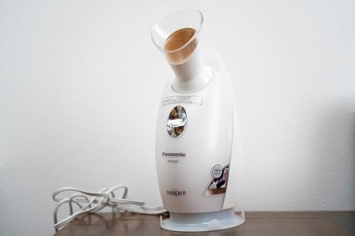 a blender sitting on top of a wooden table at Hotel HERMIT in Takamatsu