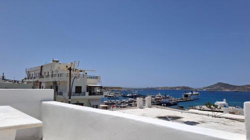 a view of a harbor from a white building at Castellino Naxos in Naxos Chora