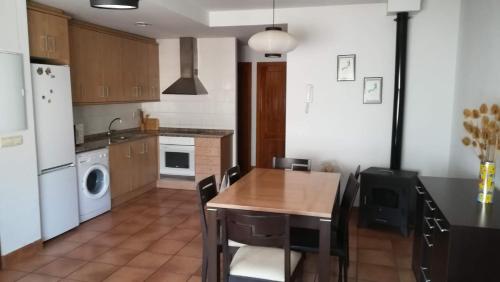 a kitchen with a table and a kitchen with a washer at Apartamento Camarena de la Sierra in Camarena de la Sierra