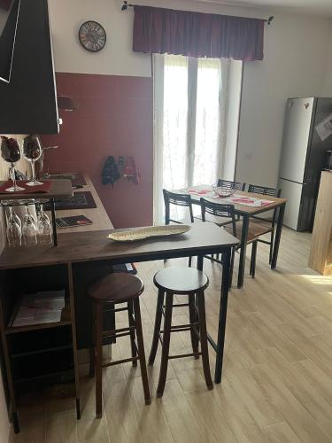 a kitchen with three tables and stools in a room at Casetta 2 in Terracina