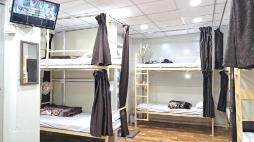 a room with bunk beds in a hostel at Maa Sheetala Dormitory in Varanasi