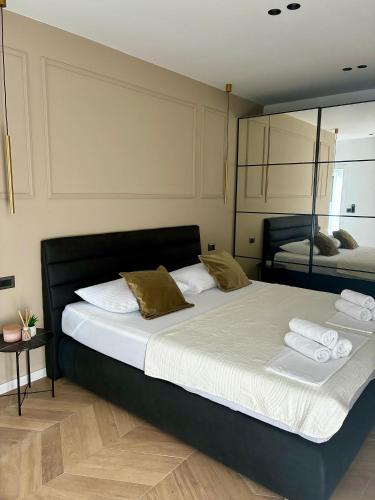 a bedroom with two beds and a mirror at Villa 5 in Makarska