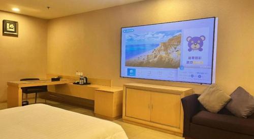 a room with a bed and a large screen on the wall at The Bauhinia in Shenzhen
