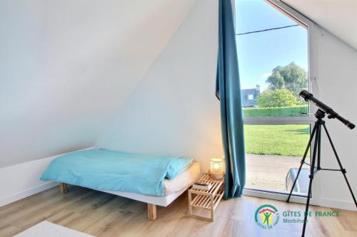 a bedroom with a bed and a camera at Tresor du port in Sarzeau