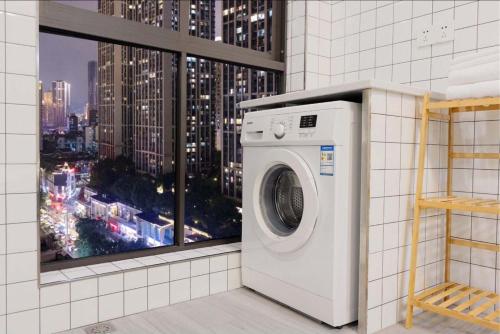 a washing machine in a room with a window at Yupan Yunge Homestay (Jiefangbei Store) in Chongqing