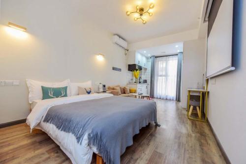 a bedroom with a large bed and a living room at Yupan Yunge Homestay (Jiefangbei Store) in Chongqing
