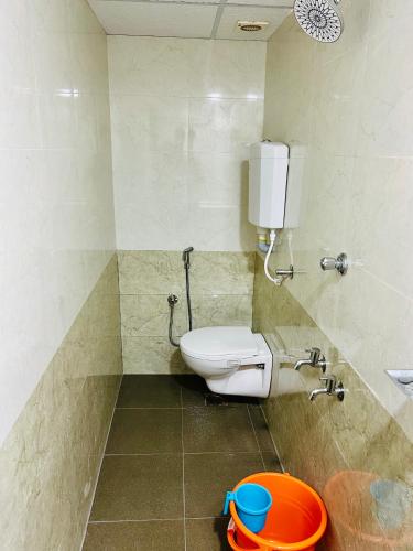 a bathroom with a toilet and a sink at COSMO LODGE in Mangalore