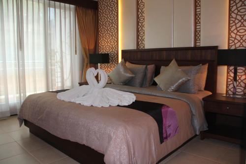 a bedroom with a bed with a white dress on it at De Arni Bangkok - SHA Extra Plus in Bangkok