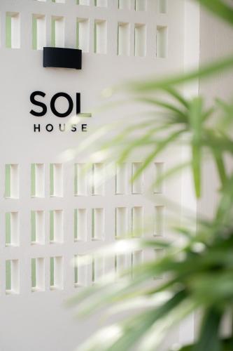 a close up of a soi house sign with a palm tree at SOL HOUSE kohlarn in Ko Larn