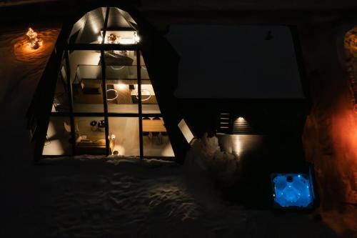 a dark room with a window and a clock at Glass Resort in Rovaniemi