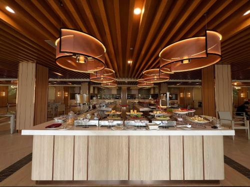 a buffet line in a restaurant with a lot of food at Swiss-Garden Beach Resort, Kuantan in Kuantan