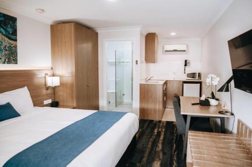 a hotel room with a bed and a desk at Comfort Inn Moree in Moree