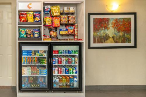 a refrigerator filled with lots of soda and snacks at Comfort Inn in Hamilton