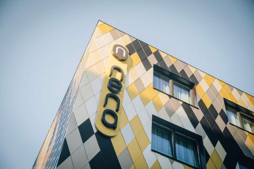 a building with a sign on the side of it at Nena Apartments München City East in Munich