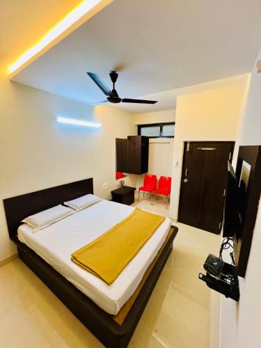 a bedroom with a large bed with a ceiling at COSMO LODGE in Mangalore