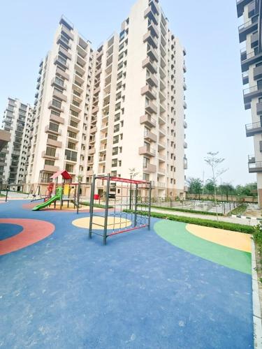 a playground in front of a large apartment building at Vrindavan Elysia in Vrindāvan
