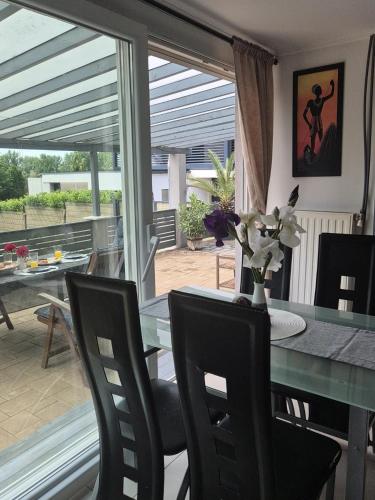 a dining room with a glass table and chairs at Coco-lak Vendégház in Sopron