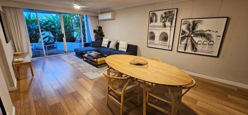 a living room with a table and a couch at Broadbeach Holiday Apartments in Gold Coast