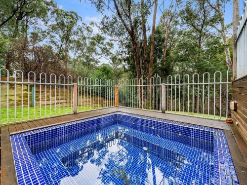 a swimming pool on a deck with a fence at Albaski Lodge Room 2 in Mount Buller