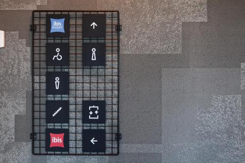 a black board with different symbols on it at ibis budget Hotel Berlin Airport in Berlin