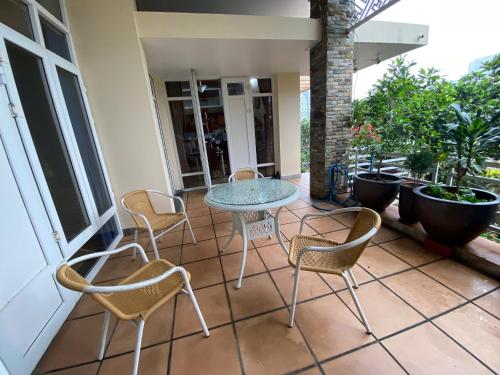 a patio with a table and chairs on a porch at Jackfruit Homestay in Ha Long