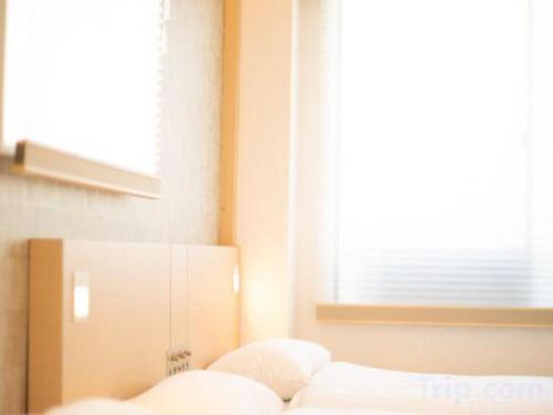 a living room with a couch and a window at NAMBA EBISU HOTEL in Osaka