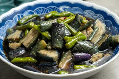 a bowl of food with green peppers and other vegetables at Sakan in Sendai
