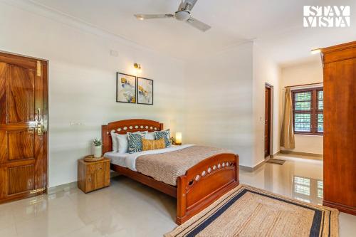 a bedroom with a bed and a window at The Canopy Your Cozy Villa Escape in the Woods Coorg in Suntikoppa