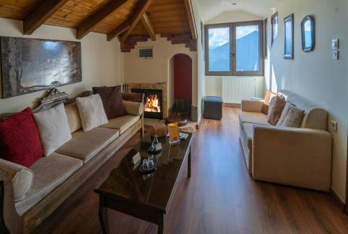 a living room with a couch and a fireplace at Semeli Guesthouse in Karpenision