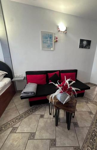 a living room with a couch and a table at Apartamenty Hexagon 35 in Grzybowo