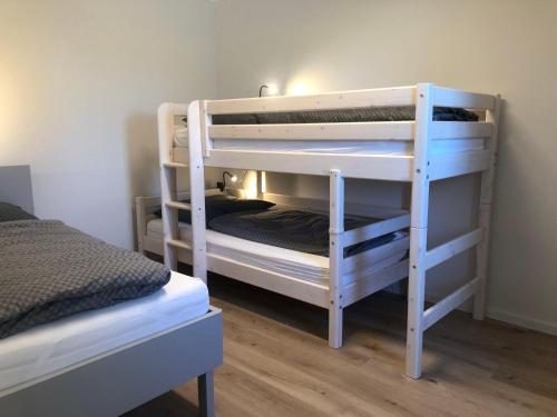 a couple of bunk beds in a room at Feriendomizil-SeeSand-2 in Gammendorf