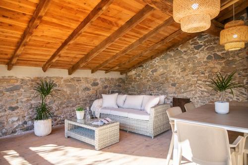 a patio with a couch and a table at L'Eixida in Sant Jaume de Llierca